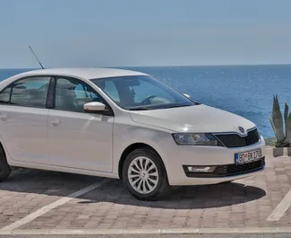 Front view of a rental Skoda Rapid in Budva, Montenegro ✓ Car #2043. ✓ Automatic TM ✓ 5 reviews.