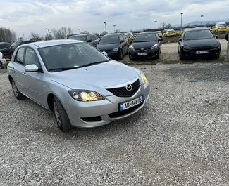 Front view of a rental Mazda 3 at Tirana airport, Albania ✓ Car #11900. ✓ Manual TM ✓ 0 reviews.