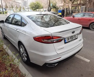 Pronájem auta Ford Fusion Sedan 2019 v Gruzii, s palivem Hybridní a výkonem 188 koní ➤ Cena od 140 GEL za den.